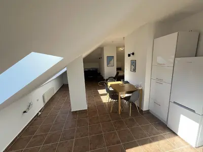 a living room with a table and a staircase at One bedroom ap 602 IN RILA PARK for 6 people in Borovets