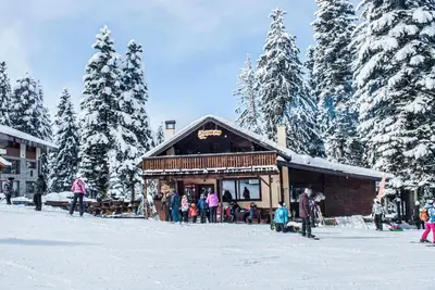a group of people standing outside of a building in the snow at One bedroom ap 602 IN RILA PARK for 6 people in Borovets