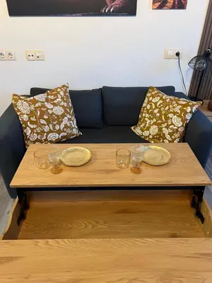 a coffee table with wine glasses and a couch at Luxury Studio1 in Hotel Friends in Bansko