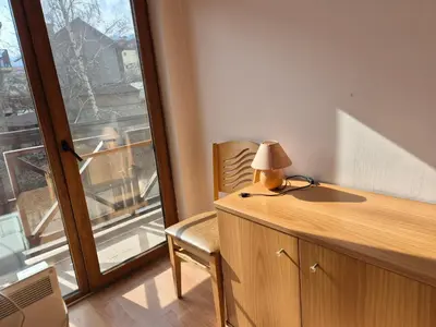 a desk with a lamp and a chair next to a window at Apartment Niko in Bansko