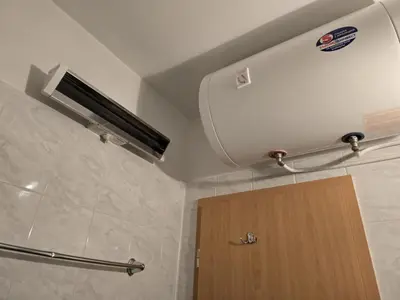 a bathroom with a shower with a toilet and a door at Apartment Niko in Bansko