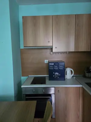 a kitchen with a stove and a microwave at Apartment Niko in Bansko