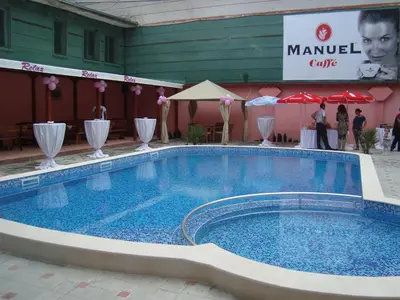 a large swimming pool in front of a building at Family Hotel Relax in Strelcha