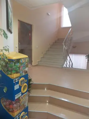 an empty room with a staircase with a bunch of balls at Family Hotel Relax in Strelcha