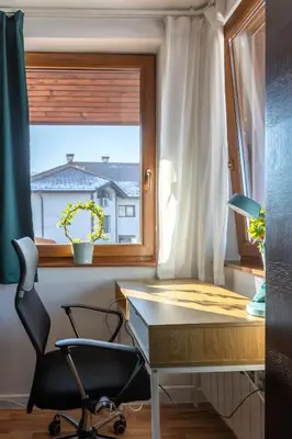 a desk and a chair in a room with a window at The Snowmad Nest - Valentina Heights, 8 min from the gondola in Bansko
