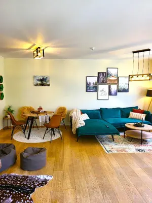 a living room with a green couch and a table at Exquisite Euphoria apartment for 4 Guests in Borovets Ski Resort in Borovets