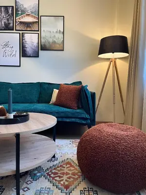 a living room with a blue couch and a table at Exquisite Euphoria apartment for 4 Guests in Borovets Ski Resort in Borovets