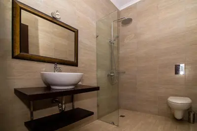 a bathroom with a sink and a shower and a toilet at Вила Белисима, Villa Bellissima in Kara Agach