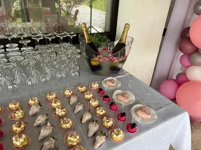 a table topped with lots of gold and wine bottles at Вила Белисима, Villa Bellissima in Kara Agach