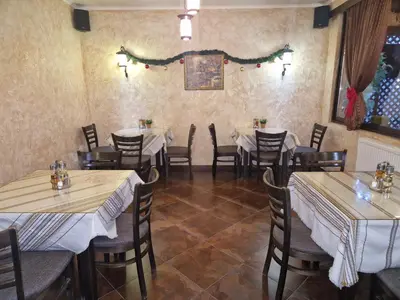 a restaurant with tables and chairs in a room at Хотел Релакс in Velingrad
