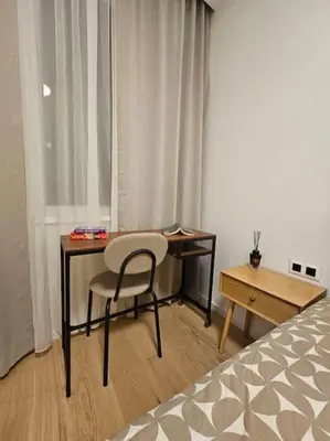 a desk and a chair in a room with a bed at The Urban Pearl in the Heart of Sofia next to National Palace of Culture in Sofia