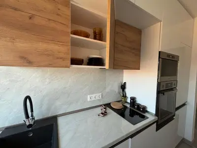 a kitchen with a sink and a stove and cabinets at Apartamento Violette OLD Town Plovdiv in Plovdiv