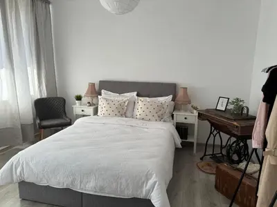 a white bedroom with a bed and a desk at Apartamento Violette OLD Town Plovdiv in Plovdiv