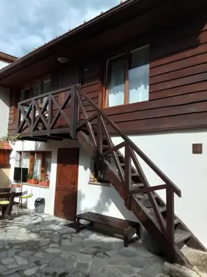 a wooden staircase on the side of a house at Студио в близост до църквата и центъра на града in Bansko