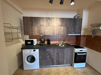 a kitchen with a washing machine and a sink at Nice, Spacious and Cozy Apartment in Sofia