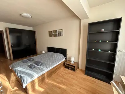 a bedroom with a bed and a flat screen tv at Nice, Spacious and Cozy Apartment in Sofia