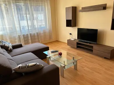 a living room with a couch and a flat screen tv at Nice, Spacious and Cozy Apartment in Sofia