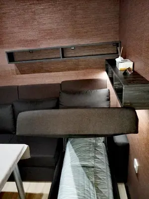 a living room with a couch and a table at Апартамент за гости в Пампорово in Pamporovo