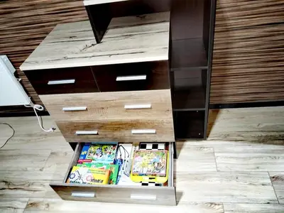 a drawer with books inside of a dresser at Апартамент за гости в Пампорово in Pamporovo