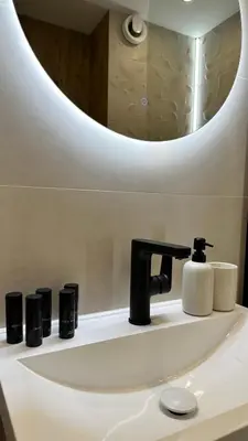 a bathroom sink with a faucet and a mirror at High End Elegant Living & Free Parking in Sofia