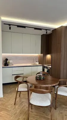 a kitchen with a wooden table and chairs and a counter at High End Elegant Living & Free Parking in Sofia