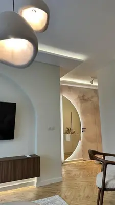 a living room with a table and a ceiling light at High End Elegant Living & Free Parking in Sofia
