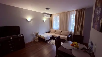 a living room with a couch and a table at Florimont Heights Apart Complex in Bansko