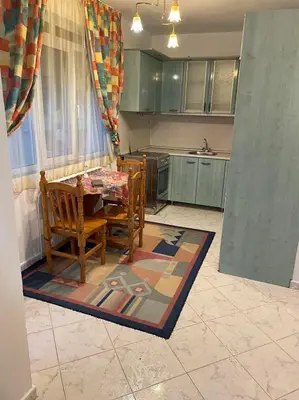 a kitchen with a table and chairs in a room at Лунара in Sandanski