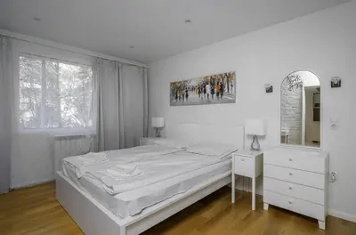 a white bedroom with a bed and a mirror at Bright & Cozy 1BD Apartment close to South Park by Flat Mаnager in Sofia