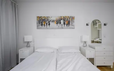a white bedroom with a bed and a mirror at Bright & Cozy 1BD Apartment close to South Park by Flat Mаnager in Sofia