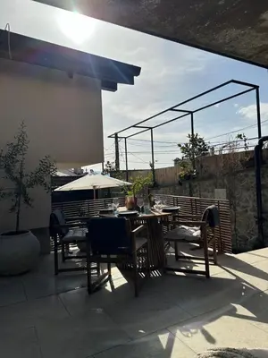 a patio with a table and chairs and an umbrella at Stylish Two Bedroom Family Villa in Sopot