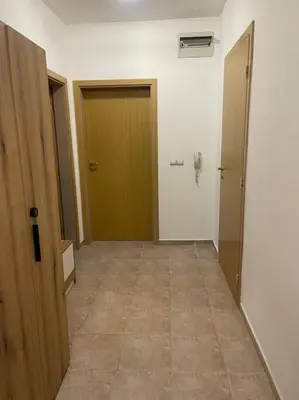 an empty hallway with two doors and a tile floor at South Mountain Apartment in Razlog