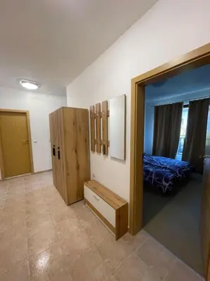 a room with a bedroom with a bed and a mirror at South Mountain Apartment in Razlog