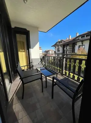 a balcony with two benches on a building at South Mountain Apartment in Razlog