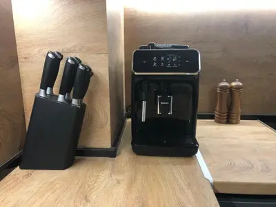 a black coffee maker sitting on a counter with knives at Stylish 2BDR apartment Gramada, free parking in Sofia