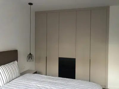 a bedroom with a bed and a large white closet at Stylish 2BDR apartment Gramada, free parking in Sofia
