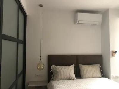 a bedroom with a bed with white sheets at Stylish 2BDR apartment Gramada, free parking in Sofia