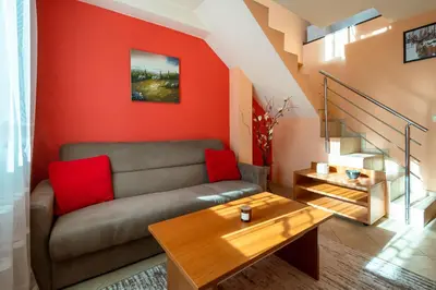 a living room with a couch and a table at Chalet Bizet cosy home in BANSKO in Bansko