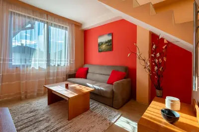 a living room with a couch and a table at Chalet Bizet cosy home in BANSKO in Bansko