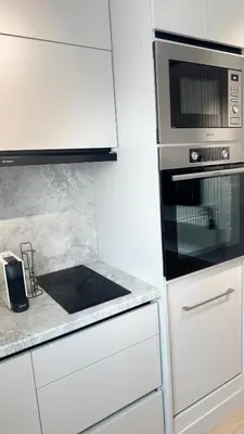 a kitchen with white cabinets and a stove top oven at Grandma Anni's House in Plovdiv