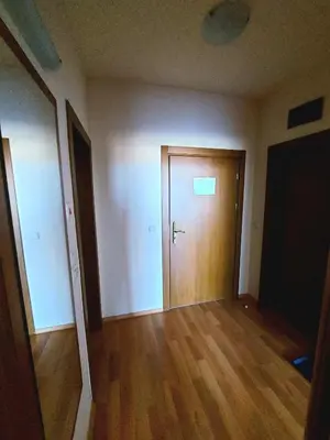 an empty room with a wooden door and wooden floors at Vihren Palace Residence, close to Gondola lift,211 in Bansko