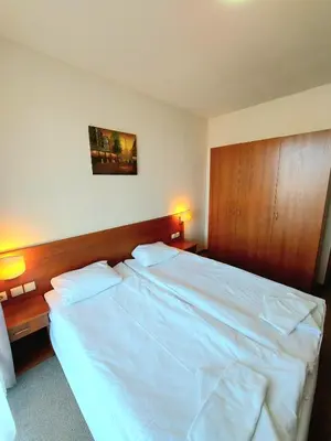 a large white bed in a bedroom with two lamps at Vihren Palace Residence, close to Gondola lift,211 in Bansko
