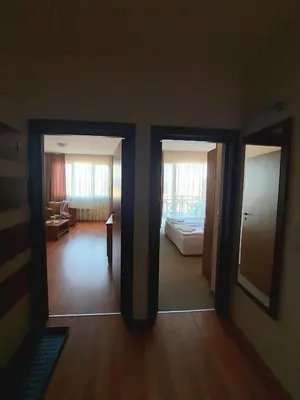 a room with two doors and a living room at Vihren Palace Residence, close to Gondola lift,211 in Bansko