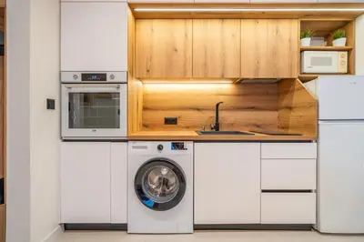 a kitchen with a washing machine and a sink at Nova Nook in Sofia