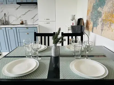 a dining room table with plates and glasses on it at PARK ESCAPE Holiday Home 24h check in in Sandanski