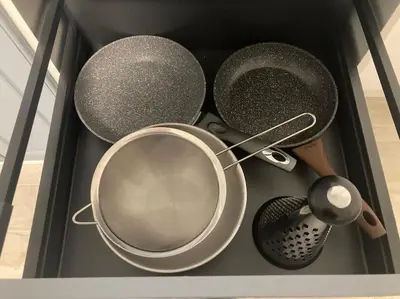 a drawer filled with pots and pans and a strainer at PARK ESCAPE Holiday Home 24h check in in Sandanski
