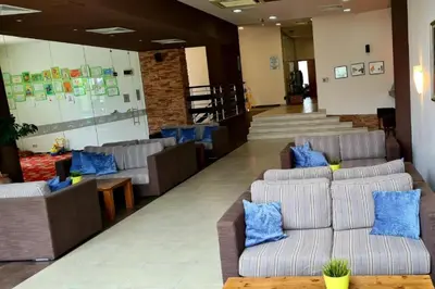 a lobby with couches and blue pillows at Aspen Golf Apartment with Stunning Mountain View in Bansko