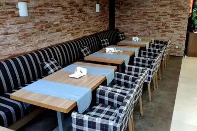 a row of tables and chairs in a restaurant at Aspen Golf Apartment with Stunning Mountain View in Bansko