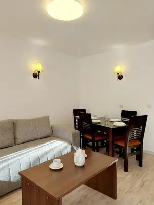a living room with a couch and a table at Dream apart-hotel, duplex apartment in Bansko