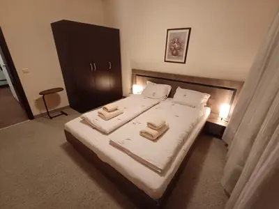 a bedroom with a bed with two towels on it at Apartment Melania in Complex Royal Towers in Bansko